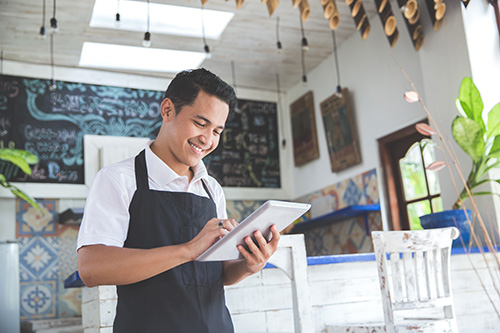 coffee_shop_owner_smiling_at_phone